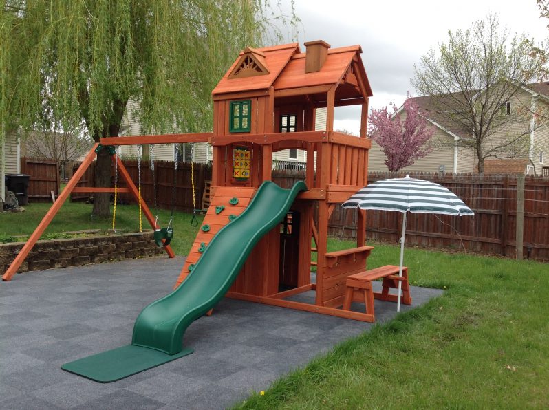 wooden playhouse with swing